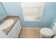 Cozy bathroom featuring a granite sink, tile flooring, and window at 1920 Partin Terrace Rd, Kissimmee, FL 34744