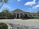 Well-maintained clubhouse exterior with elegant entrance, manicured landscaping, and ample parking for community events and gatherings at 1920 Partin Terrace Rd, Kissimmee, FL 34744