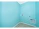 Laundry room with turquoise walls, tile flooring, and hookups at 1920 Partin Terrace Rd, Kissimmee, FL 34744