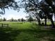 Scenic community park featuring picnic tables, lush green grass, and mature trees providing a tranquil setting at 1920 Partin Terrace Rd, Kissimmee, FL 34744