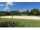 Outdoor sand volleyball court surrounded by green grass, offering a recreational space for residents to enjoy at 1920 Partin Terrace Rd, Kissimmee, FL 34744