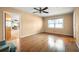 This bedroom features hardwood floors, a ceiling fan, and one window with a nice view at 198 Benjamin Dr, Ormond Beach, FL 32176