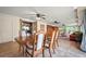 This dining room features tile flooring, chair rail details, and flows into the living area at 198 Benjamin Dr, Ormond Beach, FL 32176