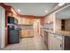 Kitchen with stainless steel appliances, light wood cabinets, and tile flooring at 198 Benjamin Dr, Ormond Beach, FL 32176