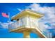 Lifeguard station on a sunny day under a blue sky with an American flag at 198 Benjamin Dr, Ormond Beach, FL 32176