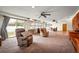 Open-plan living room featuring multiple ceiling fans and a view of the backyard at 198 Benjamin Dr, Ormond Beach, FL 32176