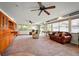 This living room features built-in shelving, an open floor plan, and three ceiling fans at 198 Benjamin Dr, Ormond Beach, FL 32176