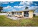 Well-appointed backyard patio with lounge chairs and sliding glass doors at 198 Benjamin Dr, Ormond Beach, FL 32176