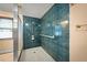 This shower features green tile, a shower head with multiple settings, and a safety bar at 198 Benjamin Dr, Ormond Beach, FL 32176