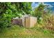 Outdoor storage shed surrounded by lush greenery at 198 Benjamin Dr, Ormond Beach, FL 32176