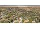 Aerial view of property with pool, manicured lawn and mature landscaping with Wekiwa Springs State Park in background at 203 E Sweetwater Creek Dr, Longwood, FL 32779