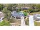 Aerial view of single-story home with manicured lawn, pool, mature trees and landscaped grounds at 203 E Sweetwater Creek Dr, Longwood, FL 32779