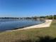 Lakefront beach area with calm waters, sandy shoreline, swimming area, and recreational facilities at 203 E Sweetwater Creek Dr, Longwood, FL 32779