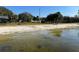 Lakefront beach area with sandy shoreline, swimming area and playground equipment at 203 E Sweetwater Creek Dr, Longwood, FL 32779