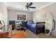 Bedroom featuring neutral walls, carpeting, ceiling fan, desk, and surfboard at 203 E Sweetwater Creek Dr, Longwood, FL 32779