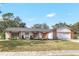 Charming single story home with brick accents, tidy landscaping, and an attached two-car garage at 203 E Sweetwater Creek Dr, Longwood, FL 32779