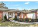 Close up of the charming home's brick accents, tidy landscaping, and front door at 203 E Sweetwater Creek Dr, Longwood, FL 32779