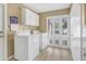 Well-lit laundry room with modern appliances and a window at 203 E Sweetwater Creek Dr, Longwood, FL 32779