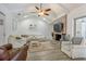 Bright living room with a brick fireplace, vaulted ceilings, and white leather furniture at 203 E Sweetwater Creek Dr, Longwood, FL 32779