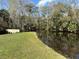 Community waterfront pond, with calm waters, features a wooden walkway offering a natural retreat at 203 E Sweetwater Creek Dr, Longwood, FL 32779