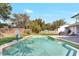 Swimming pool with lounge chairs and basketball hoop in a fenced yard at 203 E Sweetwater Creek Dr, Longwood, FL 32779