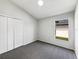 Bedroom featuring vaulted ceiling, gray walls, carpet, and a window view at 2134 Jessa Dr, Kissimmee, FL 34743