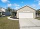 The front yard has grass, a driveway, and plants in the front yard at 2134 Jessa Dr, Kissimmee, FL 34743