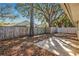 Large backyard with wooden fence, trees, and concrete patio at 2811 Curry Woods Dr, Orlando, FL 32822