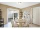 Bright dining area features neutral tones, a modern light fixture, and sliding glass doors to the back yard at 2811 Curry Woods Dr, Orlando, FL 32822