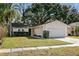 Front exterior of the home with a two-car garage and well-maintained lawn at 2811 Curry Woods Dr, Orlando, FL 32822