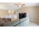 The living room features neutral tones, tile floors, a ceiling fan, and a gray sectional sofa at 2811 Curry Woods Dr, Orlando, FL 32822