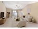 Cozy living room features neutral tones, tile floors, a ceiling fan, and modern furnishings for a serene atmosphere at 2811 Curry Woods Dr, Orlando, FL 32822