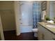 Bright bathroom features a walk-in shower, toilet, and granite countertops at 2903 Edenshire Way # 108, Kissimmee, FL 34746