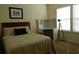 Bedroom with bed, desk and a spotlight in front of the window at 2903 Edenshire Way # 108, Kissimmee, FL 34746