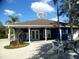 Exterior of community clubhouse with seating area and lush landscaping at 2903 Edenshire Way # 108, Kissimmee, FL 34746