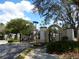 View of gated community entrance with lush landscaping and black iron gates at 2903 Edenshire Way # 108, Kissimmee, FL 34746