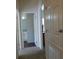 Hallway view to bathroom featuring neutral colors and a carpeted floor at 2903 Edenshire Way # 108, Kissimmee, FL 34746