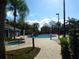 Community pool area with a hot tub, sun loungers, and palm trees at 2903 Edenshire Way # 108, Kissimmee, FL 34746