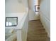 Carpeted stairs with white banister leading to the upper level of the home at 2903 Edenshire Way # 108, Kissimmee, FL 34746