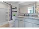 Modern bathroom with double granite vanity, spacious walk-in shower, and decorative shelving at 2987 Brie Hammock Bnd, St Cloud, FL 34773