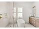 Bright bathroom featuring a glass enclosed shower, a soaking tub, and a vanity at 3011 Amherst Ave, Orlando, FL 32804