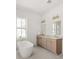 Bright bathroom featuring a soaking tub, a double vanity, and a window at 3011 Amherst Ave, Orlando, FL 32804