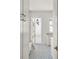 Hallway with bright lights, view to the backyard, white cabinet, and patterned floor tiles at 3011 Amherst Ave, Orlando, FL 32804