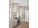 Modern kitchen with white cabinets, stainless steel appliances and marble countertops at 3011 Amherst Ave, Orlando, FL 32804