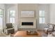 Inviting living room featuring a contemporary fireplace, comfortable seating, and natural light at 3011 Amherst Ave, Orlando, FL 32804