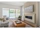 Cozy living room with a modern fireplace, comfortable seating, and a view of the outdoor pool area at 3011 Amherst Ave, Orlando, FL 32804