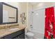 Bathroom with granite vanity, mirror, and white tiled shower/tub at 3321 Messina Dr, Lake Mary, FL 32746