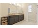 Bathroom featuring a double sink with granite countertop and a large mirror at 3321 Messina Dr, Lake Mary, FL 32746