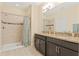 Bathroom featuring a double sink with granite countertop and tiled walk-in shower at 3321 Messina Dr, Lake Mary, FL 32746