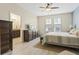 Bright bedroom featuring neutral walls, wood-look floors, dresser with tv, and ceiling fan at 3321 Messina Dr, Lake Mary, FL 32746